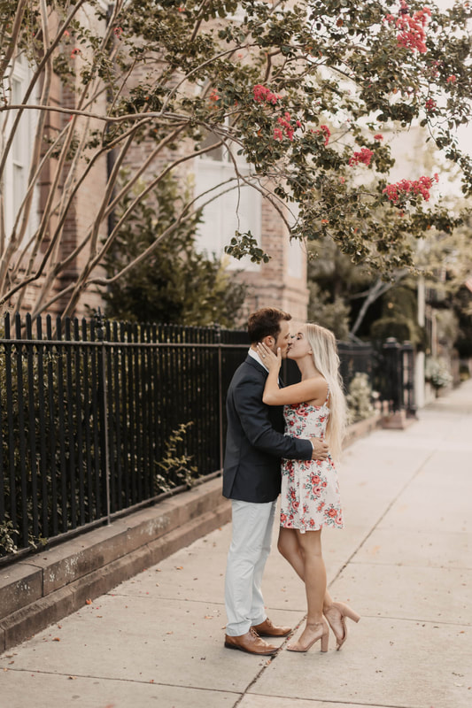 couple kissing after engagement photos