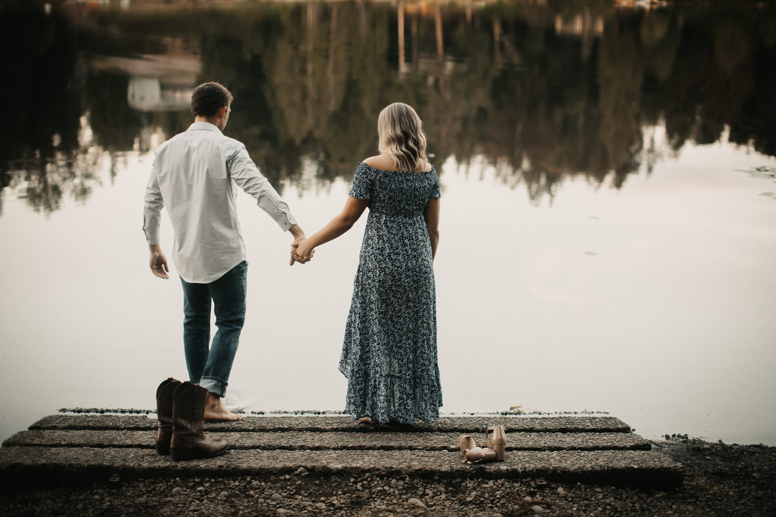 holding hands by the lake
