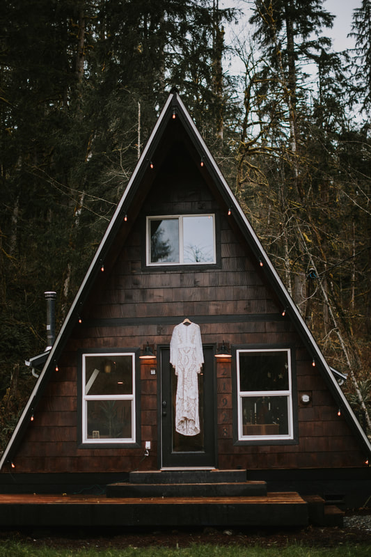 wedding dress in front of a cabin